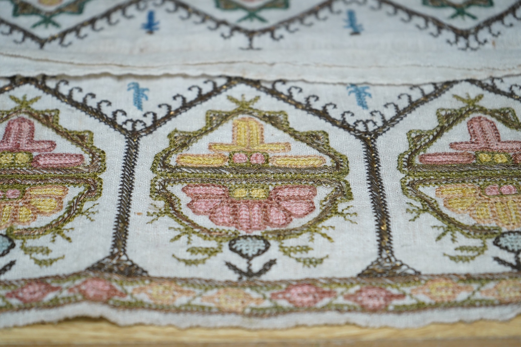 Two 19th century Turkish hand embroidered towel ends sewn together later as a table centre. Worked on fine hand woven linen in polychrome silks with gold metallic thread fillings, 39.5cm wide x 26.5cm deep. Condition - t